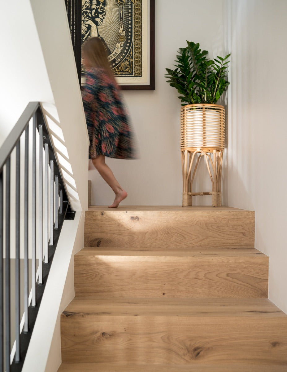 Girl running up stairs with modern flush stair nosings