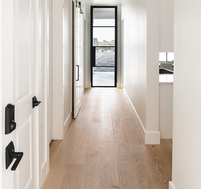 Modern wide plank white oak flooring in a hallway of a lakehouse