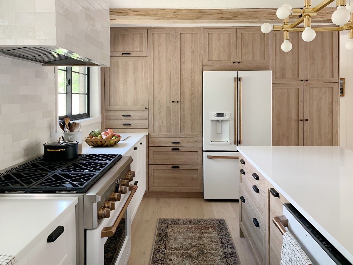 Bright kitchen renovation with wood cabinets and white oak engineered flooring by Stuga