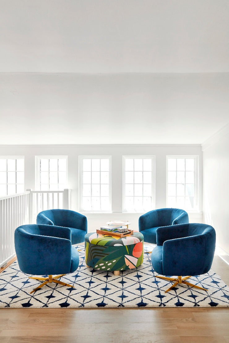 4 blue chairs sitting on patterned area rug with parkday stuga hardwood flooring